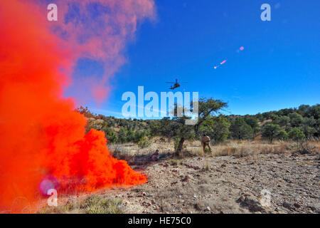 An Arizona Army National Guard UH-60A Black Hawk helicopter from Detachment 1, C Company, 5-159th Air Ambulance, based out of Phoenix, approaches simulated downed pilots after spotting smoke from simulated downed pilots during joint training at a southern Arizona military training range Jan. 20, 2015. The joint training consisted of A-10C Thunderbolt IIs from the 354th Fighter Squadron, based out of Davis-Monthan Air Force Base, and the UH-60A Black Hawk helicopter from Detachment 1, C Company, 5-159th Air Ambulance, based out of Phoenix, conducting close air support and combat search and resc Stock Photo