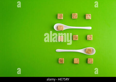 White sugar cubes in a measuring cup - Stock Image - C047/8141