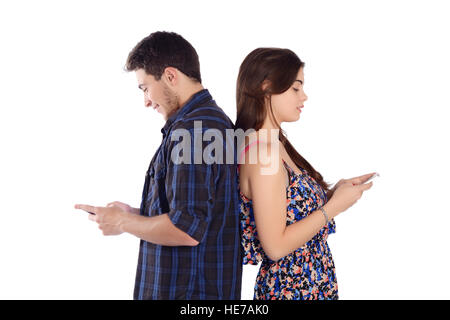 Portrait of a young beautiful couple sending messages with smartphones. Isolated white background. Stock Photo