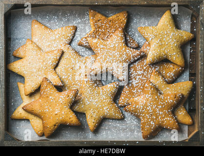 Christmas gingerbread cookies in shape of stars with sugar powder Stock Photo