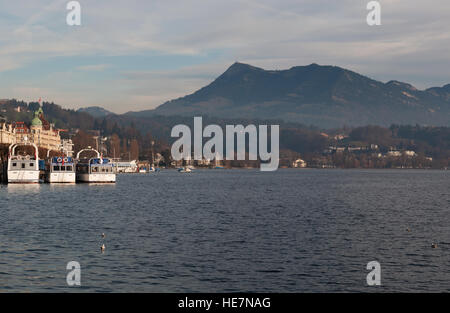 Switzerland: boats on the Lake Lucerne with view of the Swiss Alps in the medieval city of Lucerne Stock Photo