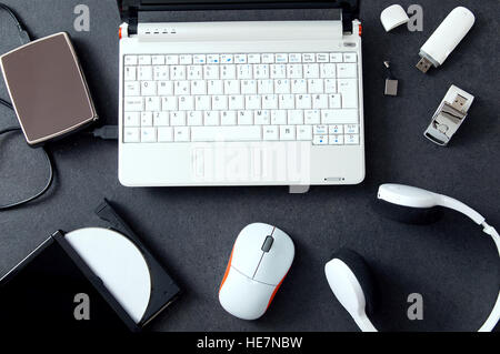 Computer peripherals and laptop accessories on white wooden background ...