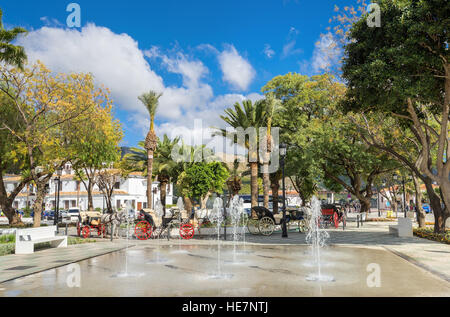 Fountain and horse carriages in town square of Mijas. Malaga province, Andalusia, Spain Stock Photo