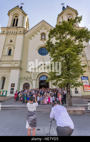 Wedding party at Transfiguration Church, 1886, Neoromanesque style, in Sanok, Malopolska, Poland Stock Photo