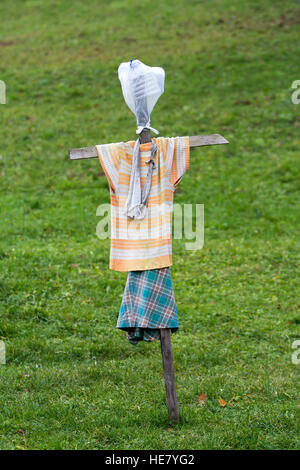 Scarecrow made of old clothes in a field Stock Photo