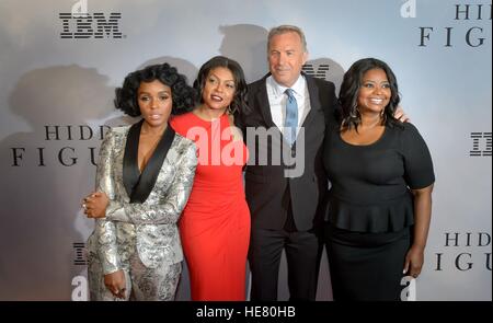 Musician Janelle Monae (left), actress Taraji P. Henson, actor Kevin Costner, and actress Octavia Spencer walk the red carpet during the global celebration event for the film Hidden Figures at the SVA Theatre December 10, 2016 in New York City, New York. The film is based on the true story of the African-American women who worked as human computers during the Friendship 7 mission in 1962. Stock Photo