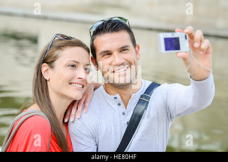 Couple taking photo of themselves with digital camera Stock Photo