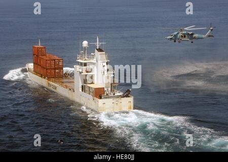 A Sikorsky SH-60F Seahawk helicopter approaches a cargo ship during the Composite Training Unit Exercise off the coast of Southern California May 14, 2009 in the Pacific Ocean. Stock Photo