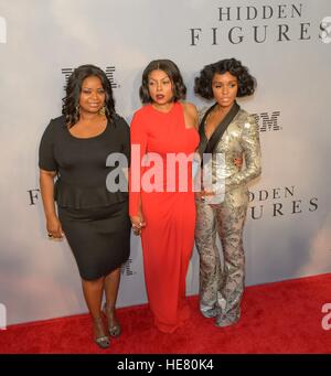 Actresses Octavia Spencer (left), Taraji P. Henson, and musician Janelle Monae walk the red carpet during the global celebration event for the film Hidden Figures at the SVA Theatre December 10, 2016 in New York City, New York. The film is based on the true story of the African-American women who worked as human computers during the Friendship 7 mission in 1962. Stock Photo