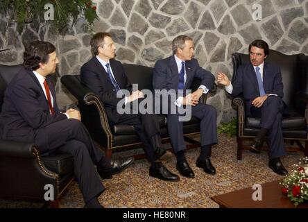 Portuguese Prime Minister Jose Manuel Durao Barroso, British Prime Minister Tony Blair, U.S. President George W. Bush, and Spanish Prime Minister Jose Maria Aznar discuss a possible war in Iraq during an emergency summit March 16, 2003 in the Azores in Portugal. Stock Photo