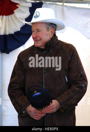 Former U.S. President George H.W. Bush wears a cowboy-style hard hat while signaling dead load launches off the flight deck of the USN Nimitz-class aircraft carrier USS George H.W. Bush during its catapult testing ceremony January 25, 2008 in Newport News, Virginia. Stock Photo