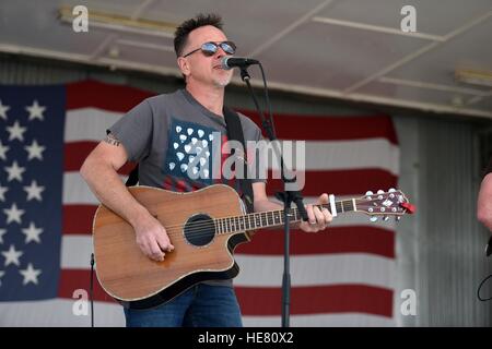 Timothy Teague plays guitar for country music singer Jarrod Niemann during the first-ever National Guard USO Tour at Camp Bondsteel May 17, 2016 near Ferizaj, Kosovo. Stock Photo