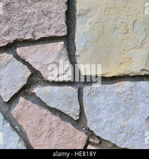 Stone fence background, vertical stonewall closeup, decorative limestone dolomite calcium carbonate hard sedimentary slate slab rock texture pattern Stock Photo