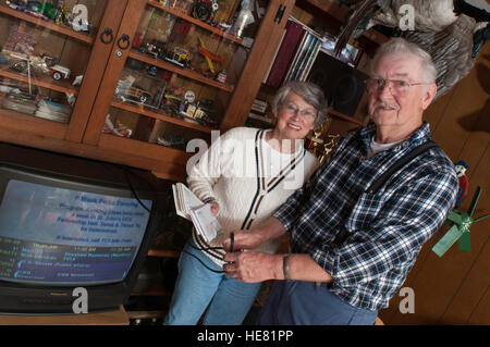 Couple frustrated with exorbitant cable tv bills Stock Photo