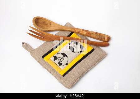 Kitchen utensils - linen potholder, wooden tools isolated on white. Stock Photo