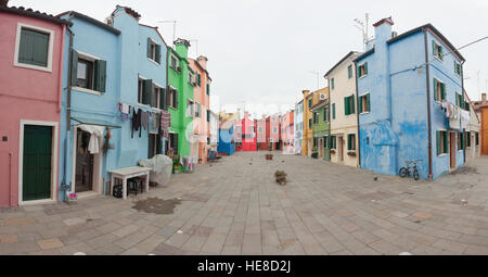 VENICE, ITALY - FEBRUARY 09, 2016: view on colorful houses from a secondary street in Burano island during a cloudy winter day Stock Photo