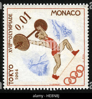 MONACO - CIRCA 1964-12-03, Postage stamp from Monaco depicting a weightlifter, issued for the 1964 Summer Olympics in Tokyo Stock Photo