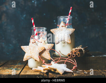 Bottles with milk, Christmas festive cookies, decoration rope, spices Stock Photo