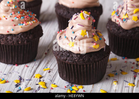 Chocolate cupcakes decorated with stars and moon on the table close-up. Horizontal Stock Photo