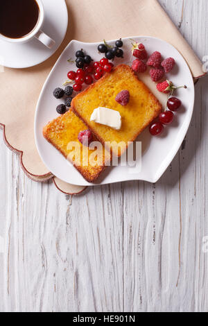 hot french toast with berries and coffee on the table. vertical top view Stock Photo