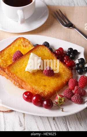 Beautiful food: French toast with berries and coffee close-up on the table. vertical Stock Photo