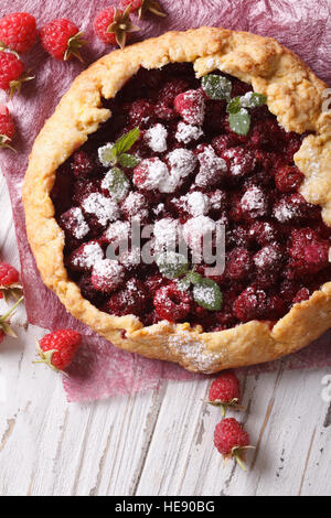 Galette cake with fresh raspberries close-up on the table. vertical Stock Photo