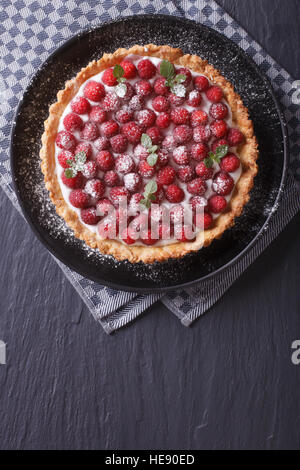 Delicious raspberry tart with whipped cream on a plate vertical view from above Stock Photo