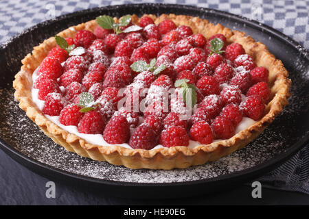 Delicious tart with fresh raspberries and mint on a plate close-up horizontal Stock Photo