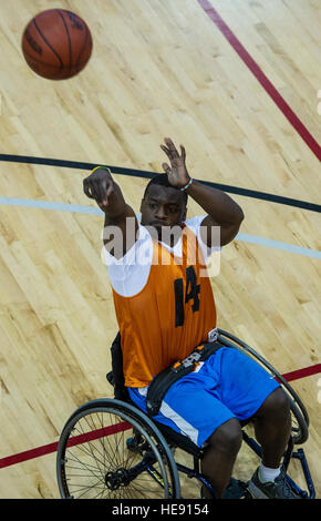 Dwayne Parker, Air Force Wounded Warrior athlete, shoots during Air Force Wounded Warrior Trials wheelchair basketball competition on Nellis Air Force Base, Nev., April 10, 2014. The Wounded Warrior Air Force Trials is a sports event designed to promote the mental and physical well-being of seriously ill and injured military veterans. More than 130 injured service men and women from around the country complete for a spot on the 2014 U.S. Air Force Wounded Warrior Team. Senior Airman Cory D. Payne) Stock Photo