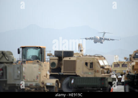 A C-17 Globemaster III aircraft deployed from McChord Airfield, Wash., descends for landing at Bagram Air Field, Afghanistan, Nov. 2, 2014. The men and women of Bagram Air Field service the Department of Defense’s busiest single runway. Airmen and civilian contractors work 24 hours a day, seven days a week to ensure airfield operations are successfully accomplished.  Master Sgt. Cohen A. Young Stock Photo