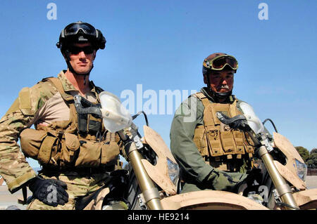 Pararescuemen, Tech Sgt. Sean Kirsch and Senior Master Sgt. Larry Hiyakumoto, both from the 131st Rescue Squadron, Moffett Federal Airfield, California Air National Guard stands by on their all terrain motorcycle, Mar 10, 2009.   Tech Sgt. Ray Aquino) Stock Photo