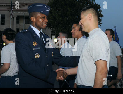 Lt. Gen. Darren W. McDew, 18th Air Force commander, shakes hands with Staff Sgt. David N. Barrios, 97th Medical Group public health technician, after a Prisoner of War/Missing in Action remembrance ceremony at the Jackson County Courthouse, Sept. 21. Stock Photo