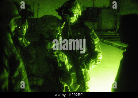 U.S. Army Soldiers, assigned to 2nd Platoon, Delta Company, 2nd Combined Arms Battalion, 69th Armor Regiment, Fort Benning, Ga., talk to a man they stopped for driving during curfew while on a foot patrol of Al Jadida, Baghdad, Iraq, Jan. 14, 2008. The presence patrols are designed to discourage enemy activity at night. (U.S. Air Force Photo/Staff Sgt. Jason T. Bailey) Stock Photo