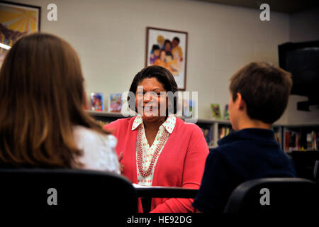 Evelyn McDew, wife of Air Mobility Command commander, Gen. Darren McDew, speaks with two Michael Anderson Elementary School associated student body members May 21, 2015, in Michael Anderson Elementary School at Fairchild Air Force Base, Wash. Mrs. McDew spoke with the students to learn more about how they felt about being a military child. Mrs. McDew met with the students to ask if they had any concerns and ensure their needs were being met. Stock Photo