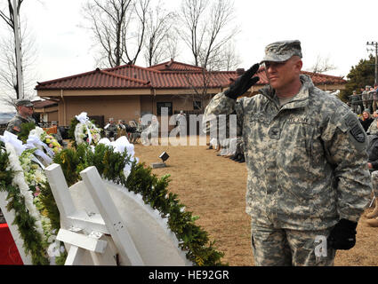 U.S. Col. Joseph Gleichenhaus, 3rd Battlefield Coordination Detachment-Korea commander, salutes a wreath honoring those who fought and those who gave their lives in the Battle of Bayonet Hill during the Hill 180 remembrance ceremony at Osan Air Base, Republic of Korea, Feb. 7, 2014. Base personnel thronged the area near the battle's monument to witness the annual ceremony and subsequent laying of the wreaths. Airman 1st Class Ashley J. Thum) Stock Photo