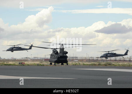 Two HH-60G Pave Hawks take off as a German air force CH-53GS taxis during an Angel Thunder 2015 mass casualty exercise at Winslow–Lindbergh Regional Airport, Ariz., June 5, 2015. U.S. military forces and partner nations worked together during the exercise to transport simulated patients from Camp Navajo Training Site to the casualty collection point located at the Winslow–Lindbergh Regional Airport. Tech. Sgt. Courtney Richardson) Stock Photo