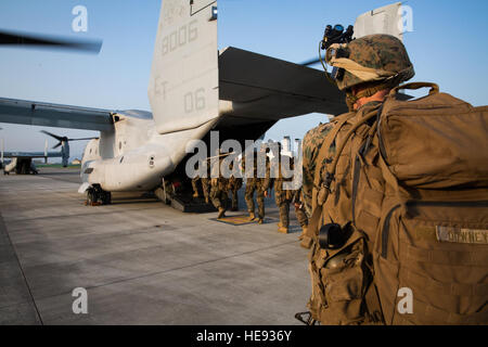 U.S. Marines assigned to Echo Co., Battalion Landing Team 2nd Battalion, 4th Marines, 31st Marine Expeditionary Unit (MEU), board MV-22B Osprey tiltrotor aircraft from Marine Medium Tiltrotor Squadron 262, 31st MEU, at Marine Corps Air Station Iwakuni, Japan, July19, 2016. As the Marine Corps' force-in-readiness, the 31st MEU trains in a number of unique capabilities for rapid crisis response.  Cpl. Darien J. Bjorndal, 31st Marine Expeditionary Unit/ Released) Stock Photo