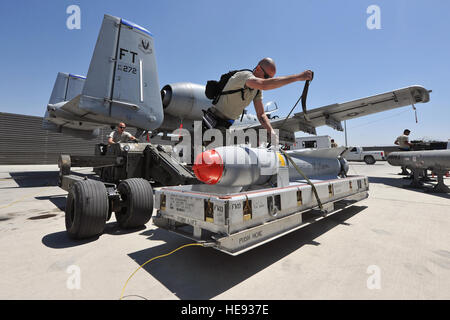 Weapon loaders from the 74th Expeditionary Fighter Squadron prepare to load ammunition onto an A-10 Thunderbolt II on Bagram Air Field, Afghanistan, May 8, 2013. The aircraft can deploy general purpose bombs, cluster bomb units, laser guided bombs, joint direct attack munitions, wind corrected munitions dispenser, AGM-65 Maverick and AIM-9 Sidewinder missiles, rockets, illumination flares, and the GAU-8/A 30mm cannon, capable of firing 3,900 rounds per minute.  Senior Airman Chris Willis) Stock Photo