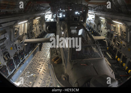 One of two Apache helicopters from Fort Bliss, Texas sits in the back of a C-17 Globemaster III at Al Udeid Air Base, Qatar, Dec. 13. The C-17, which is deployed from the 62nd Airlift Wing at Joint Base Lewis-McChord, Wash., delivered the helicopters. The helicopters are scheduled to take part in the annual Qatar National Day parade set for Dec. 18.  Tech. Sgt. James Hodgman Stock Photo