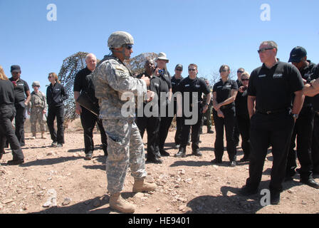 Sgt. Romero, Arizona Army National Guard soldier, provides students from the Executive Leadership Development Program instructions on daily entry identification team site operations, Apr. 12. The training was part of a joint effort between Customs and Border Protection and the Arizona National Guard, to give the students a perspective on joint and interagency efforts to secure the border. Stock Photo