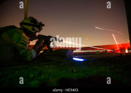 An Iraqi soldier, assigned to the Security Battalion, Nineveh Operations Command, fires his AK-47 rifle during night range training at Camp Taji, Iraq, April 3, 2016. Task Group Taji conducted night range training to gague soldiers night firing capabilities. Training at the building partner capacity sites is an integral part of Combined Joint Task Force – Operation Inherent Resolve’s multinational effort to train Iraqi security force personnel to defeat the Islamic State of Iraq and the Levant. (U.S. Army  Spc. William Lockwood Stock Photo