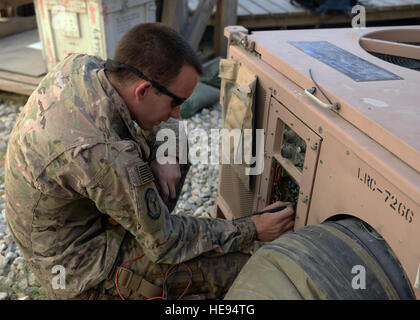 An HVAC technician from the 455th Expeditionary Civil Engineer Squadron performs maintenance on an air conditioning unit at Bagram Air Field, Afghanistan, supporting operational mission equipment and base facilities. Stock Photo
