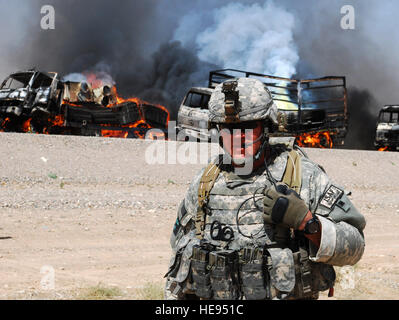 Capt. Samuel Shepherd, Headquarters Company commander, 1st Battalion, 12th Infantry Regiment, radios Forward Operating Base Ramrod for additional support after a civilian convoy was ambushed July 20 on Highway 1 in the Kandahar province. U.S. Soldiers from the 1-12th IN helped Afghan national police secure the site after the ambush. According to the ANP, one driver was injured after insurgents pulled the truckers out of the vehicles and set fire to their trucks. Stock Photo