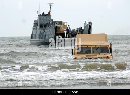 A High Mobility Multipurpose Wheeled Vehicle (HMMWV or Humvee) exits from an utility landing craft from the amphibious assault ship USS Nassau (LHA 4) onto the beach of Galveston, Texas to begin disaster relief efforts Sept. 18. The Nassau is anchored off Galveston to render disaster response and aid to civil authorities as directed in the wake of Hurricane Ike.   Staff Sgt. Bennie J. Davis III) Stock Photo