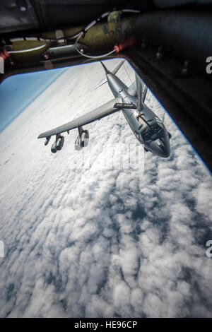 Staff Sgt. Shawna Sims, a 92nd Air Refueling Squadron KC-135 Stratotanker boom operator from Fairchild Air Force Base, Wash., connects with a B-52H Stratofortress from Minot Air Force Base, N.D., during an aerial refueling mission as part of exercise Amalgam Dart 15-2 May 28, 2015, over the Alaskan coastline. Amalgam Dart, a North American Aerospace Defense Command exercise, is an annual training opportunity affording American and Canadian forces field training exercises aimed at improving NORAD’s operational capability in a bi-national environment. The exercise spanned two forward operating l Stock Photo
