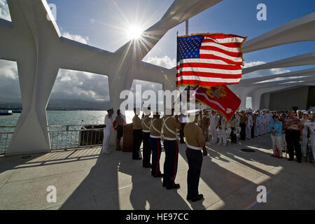 Joint Service Navy and Marine Corps Color Guard display the colors on the USS Arizona Memorial, June 4, 2012, during the singing of the national anthem. World War II veterans, civilian guests, and sailors, Marines, and airmen assigned to Military bases on Hawaii gathered at the USS Arizona Memorial for a wreath laying ceremony to commemorate the 70th Anniversary of the Battle of Midway. Stock Photo