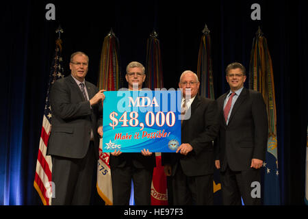 Deputy Secretary of Defense Bob Work (left) and Director of Administration Office of the Deputy Chief Management Officer Mr. Michael Rhodes (right) pose for a photo during the presentation of Combined Federal Campaign goals during the 2014 Department of Defense Combined Federal Campaign of the National Capital Area Kickoff Ceremony at the Pentagon, Washington D.C., Sep. 4, 2014. ( Master Sgt. Adrian Cadiz)(Released) Stock Photo