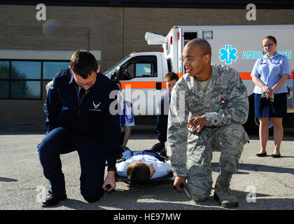 Airman Gilbert Clark, 22nd Aerospace Medicine Squadron medical technician, shows a group of Derby High School Junior ROTC cadets how to carry a litter, March 11, 2015, at McConnell Air Force Base, Kan. Clark was one of several Airmen to show cadets from local schools what the Air Force medical career field is like during a base tour.  Senior Airman Victor J. Caputo) Stock Photo