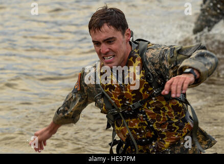 U.S. Army 1st Lt. Christian Groom, 1st Armored Division, exits Victory Pond after swimming toward the next event at Fort Benning, Ga., April 15, 2016. The 33rd annual Best Ranger Competition 2016 is a three-day event consisting of challenges to test competitor's physical, mental, and technical capabilities. (U.S. Airforce  Senior Airman Keith James Stock Photo