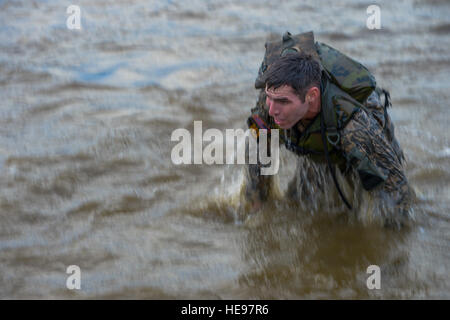 U.S. Army 1st Lt. Patrick Decker, assigned to the 1st Armored Division, comes out of the water after completing the pond swim during the Best Ranger Competition on Ft. Benning, Ga., April 15, 2016. The 33rd annual Best Ranger Competition 2016 is a three-day event consisting of challenges to test competitor's physical, mental, and technical capabilities in honor of Lt. Gen. David E. Grange, Jr.  Senior Airman Colville McFee Stock Photo